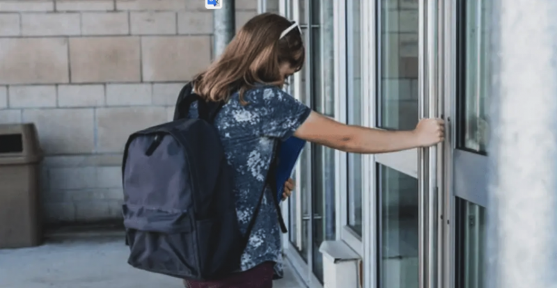 Image of female student opening a door
